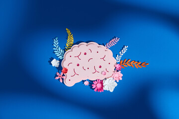 Detailed paper art featuring a human head with blooming brain