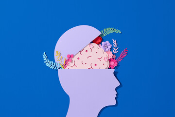 Paper cut of human head with floral brain