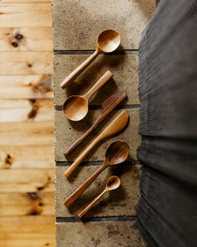 Hand-Carved Wooden Spoons on Tile
