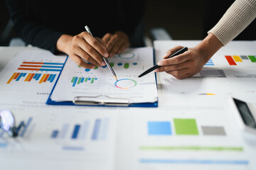 Business Team Analyzing Financial Charts and Graphs During a Meeting in a Modern Office