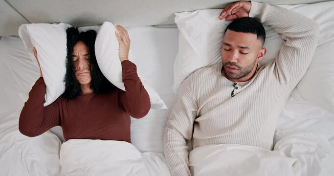 Home, couple and snoring with noise in bed, annoyed wife and sensitive to sound of husband. Married people, woman and man with nasal congestion, anatomy and sleep apnea in bedroom with awake girl