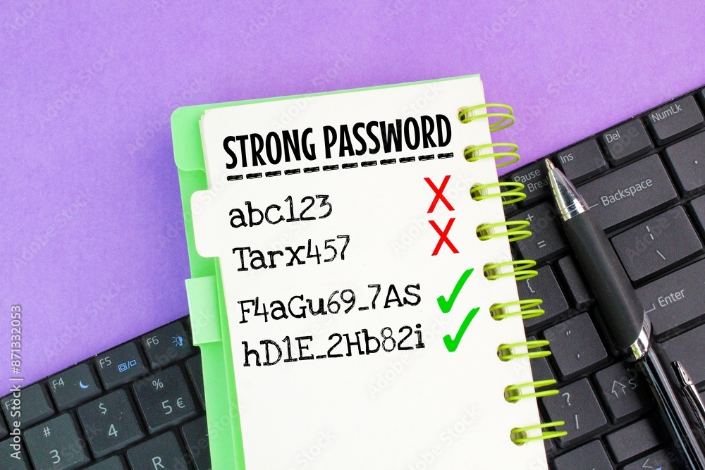 Poster laptop keyboard and book with the word strong password. the concept of finding a strong password. co