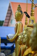 Standing Buddha statue. Buddhist sculpture. Statues of Buddha.