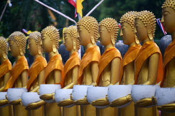 Standing Buddha statue. Buddhist sculpture. Statues of Buddha.