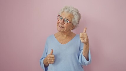Cheerful grey-haired senior woman confidently showing ok sign, expressing joy and approval, standing over isolated pink background, gleaming with a positive, successful lifestyle.