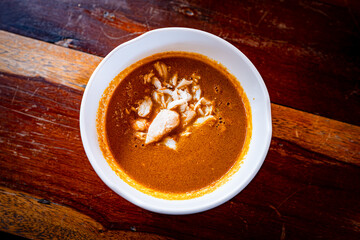 Crab Meat Curry Sauce (Nam-Ya-Poo), wood background.