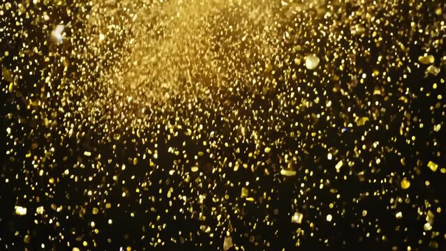 Shower of golden glitter confetti against dark background. Shimmering particles creating festive atmosphere. Luxury celebration concept with sparkling gold flakes floating in air.	
