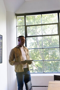 Presenting business proposal, man holding tablet and speaking in office meeting, copy space