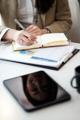 Woman hand using pen writing on notebook