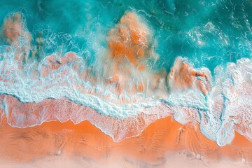 Aerial view of turquoise ocean waves crashing on an orange sandy beach, creating a stunning contrast of colors and textures.