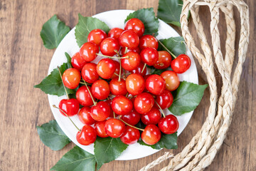 Close up shot Red Cherry fruit on wooden background, Japanese Red highest variety of Yamagata cherries on white table.