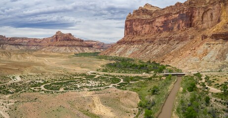 San Rafael river, grassland and camping ground in the desert and tall buttes. Buckhorn Wash, Utah, United States of America.