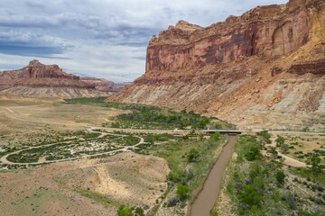 San Rafael river, grassland and camping ground in the desert and tall buttes. Buckhorn Wash, Utah, United States of America.