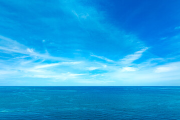 Ocean background and sea water and clear sky. For summer vacation ideas The nature of the beach and summer sea with the sun shining on the sea sparkling against the blue sky
