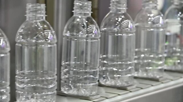 The  empty drinking water bottles  on the conveyor belt for filling process.
