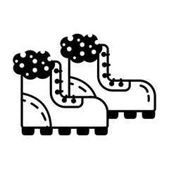 An icon of hiking boots in glyph style  