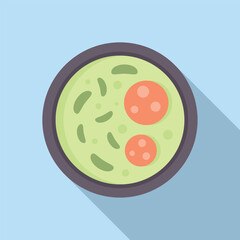 Bowl of green pea soup with slices of sausage on a blue background