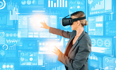 Caucasian business woman using VR goggle to look at financial data analysis while standing at...