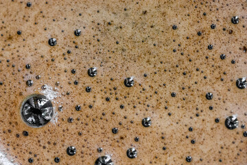 The surface of hot coffee in close-up