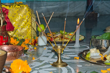 still picture image of floor where holy puja is performed alongwith utensils incense sticks and candles in India