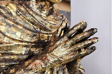Close up Golden Hands of Monk Statue.