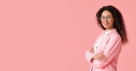 Young African-American businesswoman on pink background with space for text