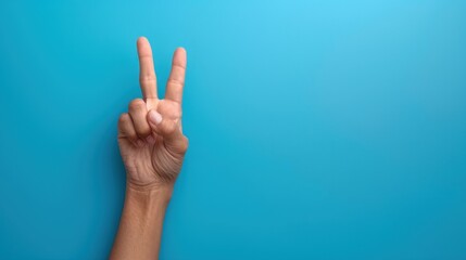 Fototapeta premium Hand making a peaceful gesture, peace hand gesture, symbol of goodwill, International Peace Day, 