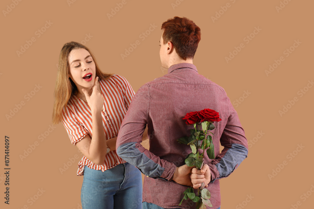 Sticker Young man with roses for his beloved girlfriend on brown background