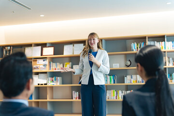A Caucassian woman giving a speech in the lobby