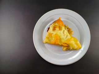 Cheesy and Meaty Pizza on Small White Plate Against Dark and Ash Abstract Background: Enjoy a Savory Delight with Melted Cheese and Flavorful Meat, Perfectly Presented for Your Culinary Pleasure