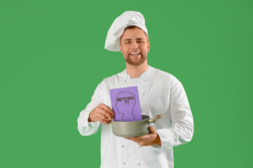 Male chef holding paper with text REMEMBER IT on green background