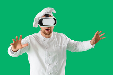 Male chef using VR glasses on green background