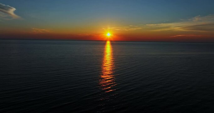Aerial tracking shot over the sea, calm, summer sunset, in Kalajoki, Finland