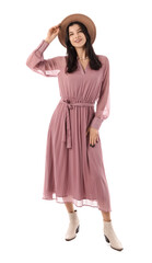 Beautiful young woman in stylish pink dress and hat on white background