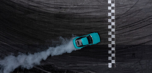 Aerial top view car drifting diffusion race drift car with lots of smoke from burning tires on speed track, Professional driver drifting car with lots of white smoke .