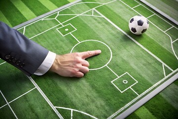 Fototapeta premium coach point finger on football tactic strategy map diagram