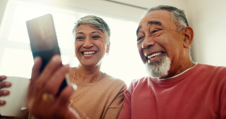 Laughing, phone or senior couple on social media for funny meme or website notification in home. Smile, bonding or happy elderly people texting on networking mobile app chat or reading news to relax