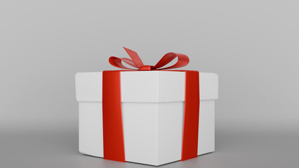 a white gift box with a red ribbon