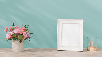 a vase with pink flowers and a picture frame