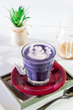 a cup of hot taro with latte art and sweet sugar