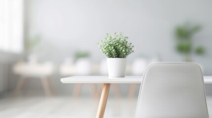 Fototapeta premium Minimalist office space with white desk, chair, and potted plant. Bright and uncluttered environment promoting productivity and focus.