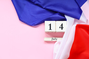 Flag of France and cube calendar with date 14 JULY on pink background. Bastille Day celebration