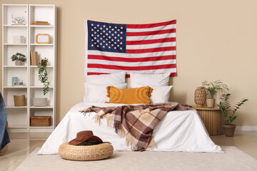 USA flag and comfortable bed in interior of bedroom
