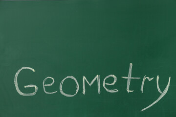 Word GEOMETRY written on green chalkboard