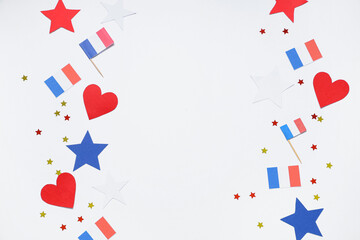 Obraz premium French flags, stars and confetti on white background. Bastille Day celebration