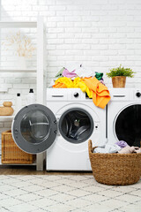 Pile of Laundry Awaiting Washing Machine in White Brick Laundry Room