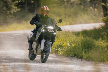 Modern adventure motorcycle on a ride on gravel surface. Motorcycling in nature or offroad,...