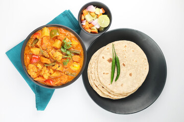 Mix vegetable curry - Indian main course recipe contains Carrots, cauliflower, green peas and beans, baby corn, capsicum served with Chapati