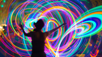 Person spinning LED light poi during a festival at dusk creating colorful long exposure trails in the air.