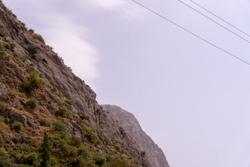 A mountain with a cloudy sky in the background
